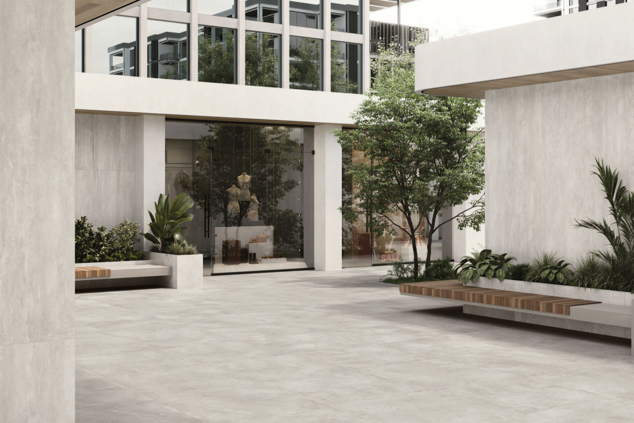 Side-by-side Caesar Civic concrete-effect and Prima clay-effect porcelain tiles texture comparison for Dubai commercial interior design